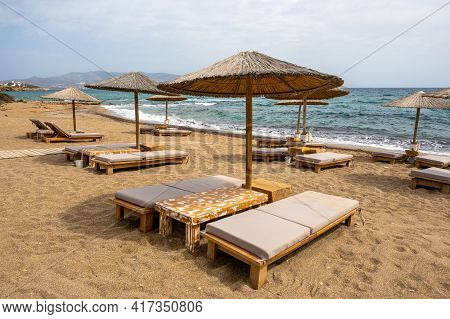 Sun Beds And Umbrellas At Soros Beach On Antiparos Island. A Wonderful Beach With The Golden Sand An