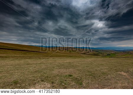 Gathering Dramatic Stormclouds Over The Green Valley At Early Spring In Transylvania.