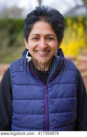 Asian Indian Middle Aged Menopausal Woman Outdoors Looking Happy In England, Uk
