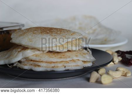 Rice Pancakes And Hoppers. Two Types Of Red Rice Breakfast Dishes Along With Chicken Curry Made With