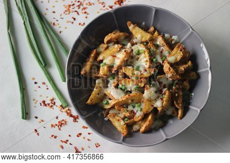 Cheesy Potato Wedges Made By Baking Air Fried Potato Wedges After Sprinkling It With Shredded Mozzar