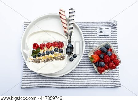 Fresh Yogurt With Fruits, Granola, Chia Seeds Und Napkin