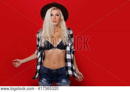 Attravtive Young Woman With Blonde Long Hair, Posing Sexy With Bare Abdomen, In Underwear, Over Red 
