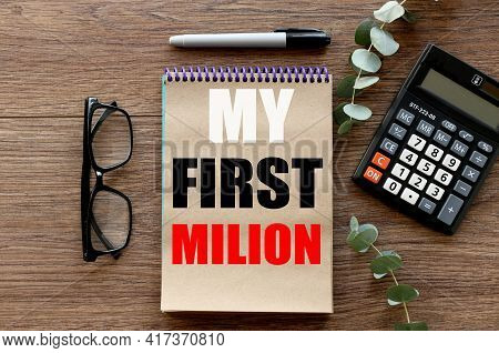 Lies On A Wooden Background, A Notebook With Craft Pages. Text On Notepad. Blackboard With My First 