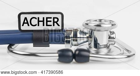 Medicine And Health. On The White Surface Lies A Stethoscope With A Plate With The Inscription - Ach