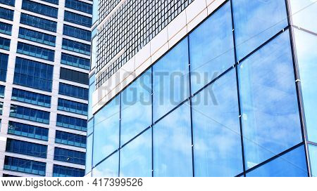 Abstract Closeup Of The Glass-clad Facade Of A Modern Building Covered In Reflective Plate Glass. Ar