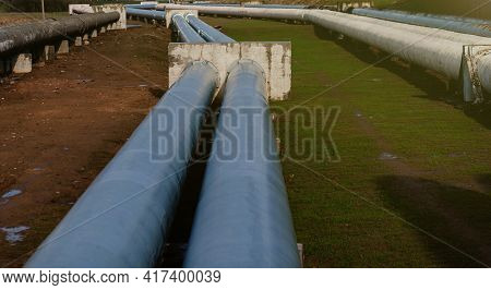 Elevated Heat Pipes. Pipeline Above Ground, Conducting Heat To Heat City. Urban Line In Metal Insula