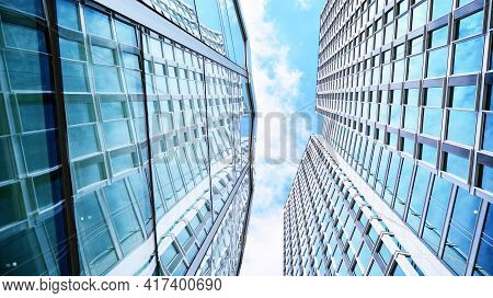 Abstract Closeup Of The Glass-clad Facade Of A Modern Building Covered In Reflective Plate Glass. Ar