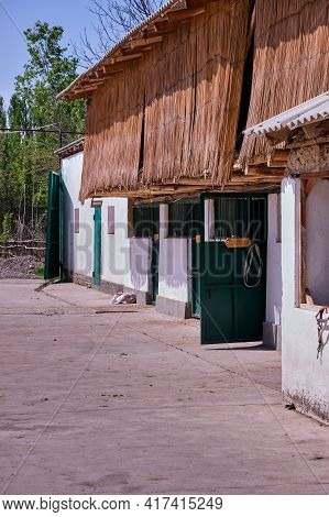 Stables In The Village. View Of The Stable, Attic With Hay For Horses