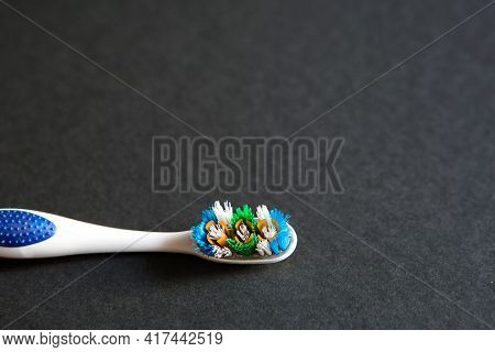 A Used Toothbrush With Disheveled Bristles On A Black Background. Replacement Of The Toothbrush, Unh