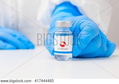 Sinovac Vial Or Bottle With Pharmaceuticals Demonstrated By Health Worker Or Scientist In Rubber Glo