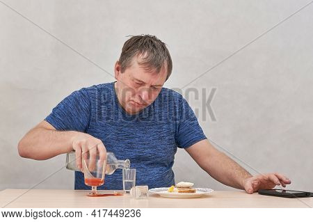 The Man Pours Alcohol And Tries To Make A Phone Call