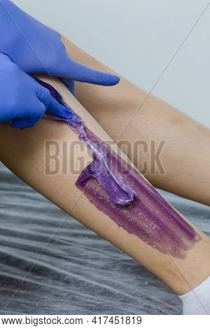 Hands Of Beautician Accomplishing Woman Legs Depilation By Using Sugaring Technique On Female Legs I