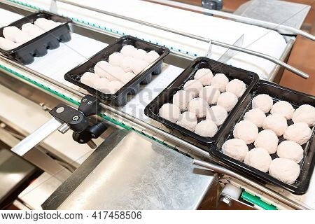 Chicken Semifinished Product Line. Raw Cutlets On A Conveyor Belt.