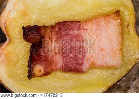 Half Of Potato In Their Skin Baked Together With Bacon Slice On A Baking Sheet, Fragment Top View Cl