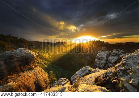 Saxon Switzerland Elbsandstone Dark Cloudy Sunset At National Park Rock Peak Above Forest