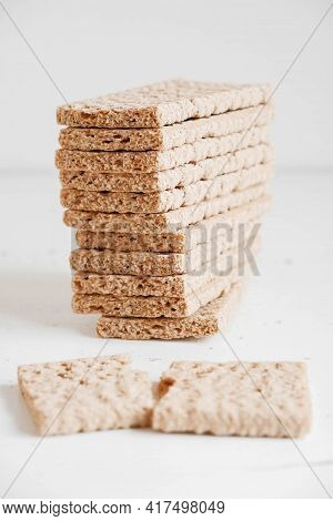 Stacked Rye Crisp Bread On A White Wooden Background. Copy, Empty Space For Text