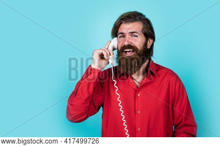 Brutal Caucasian Hipster With Beard In Shirt Speak On Retro Phone, Communicatio