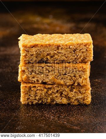 Stack Of Three Pieces Of Golden Syrup Flapjack As Background, Healthy Sweet Snack.