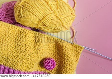 Knitting Accessories Skeins Of Yarn Knitting Needles And Knitted Blanks On A Pink Background Needlew