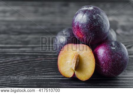Chilean Plums And Plums In A Cut On A Dark Wooden Background Kopi Space