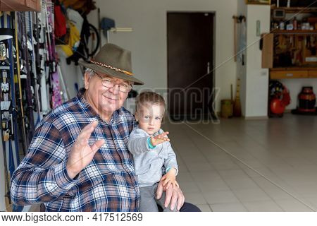Happy Senior Caucasian Old Male Person Portrait Sitting At Home Garage Workhouse With Cite Little Ch