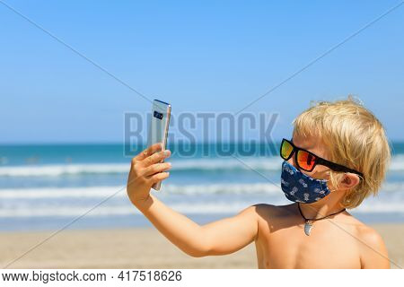 Funny Boy Taking Selfie Photo By Smartphone On Tropical Sea Beach. New Rules To Wear Cloth Face Cove