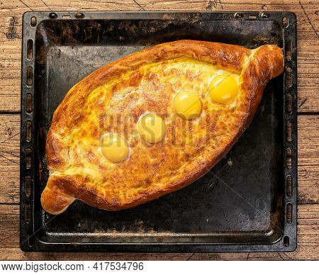 Khachapuri On A Baking Sheet On The Wood Table