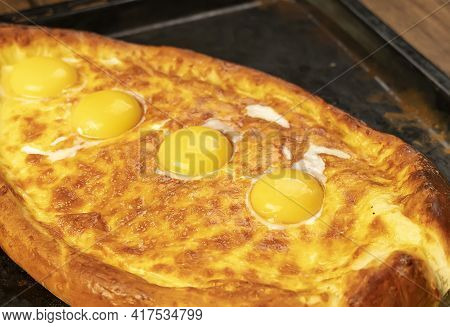 Khachapuri On A Baking Sheet On The Wood Table