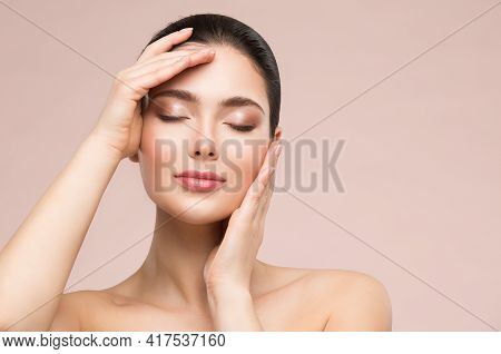 Beautiful Woman Face Skin Care. Natural Make Up. Skin Health Treatment. Model Massaging Face By Hand