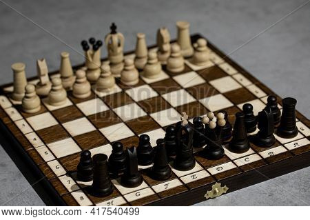 Wooden Chess Pieces On Board, Arranged In Incorrect Initial Position. White King Wrong Chessboard Sq