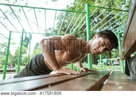 Close Up Of A Handsome Man Doing Push Ups To Build Chest Muscles And Lose Weight By Exercising Outdo