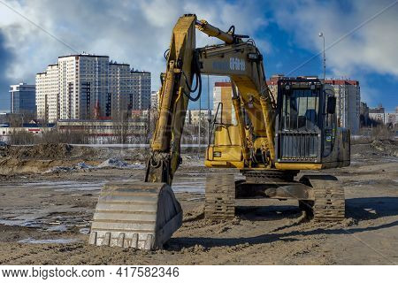 Yellow Excavator Or Bulldozers In Town. Surgut, Russia - 20 April, 2021