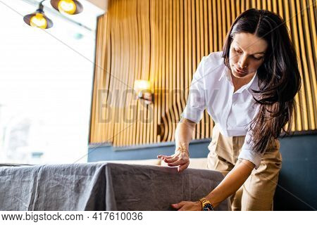 Indian Woman Setting The Table For Dining In Day Light Room