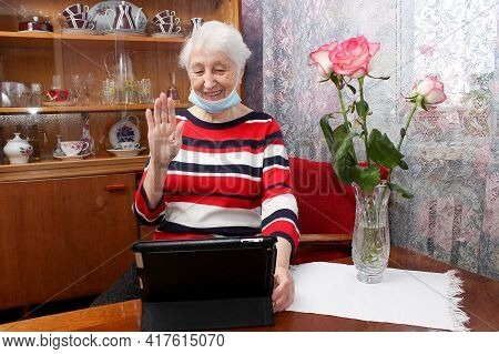 Covid-19 Stay Connected. Happy Senior Woman At Home Video Calling Family On Laptop Or Online Chattin