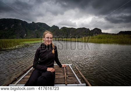 Beautiful Landscape With Young Happy Tourist In Van Long Nature Reserve, Tam Coc, Ninh Binh In Vietn
