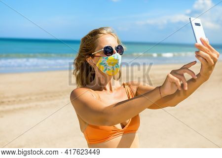 Funny Girl Taking Selfie Photo By Smartphone On Tropical Sea Beach. New Rules To Wear Face Mask At P