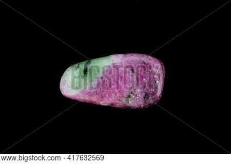Ruby Zoisite Jewel Stone Texture On Black Background. Macro Closeup.