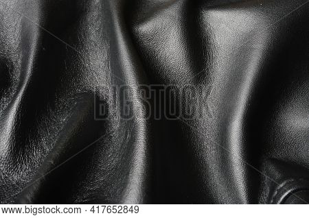Texture Of Black Leather Or Dermantin With Folds, Used As Material For Women's And Men's Bags, Suitc
