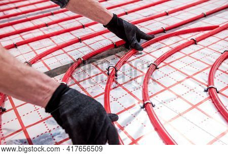 Pipefitter Install System Of Underfloor Heating System At Home