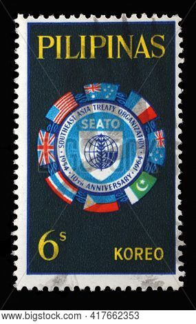 ZAGREB, CROATIA - SEPTEMBER 18, 2014: Stamp printed in Philippines shows Flags surrounding SEATO emblem, 10th anniversary SEATO, circa 1964