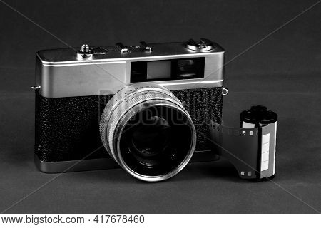 Monochrome Vintage Film Rangefinder Camera With Roll Of Film
