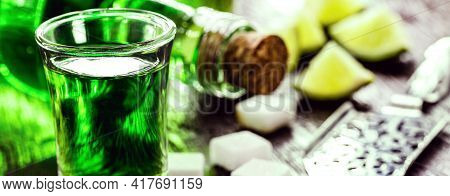 Doses Of Absinthe With Sugar Cubes. Absinthe Bottle, Green Distilled Drink