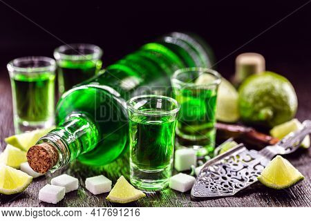 Doses Of Absinthe With Brown Sugar Cubes. Distillate Of Absinthe In A Glass And Lemon, Stainless Ste