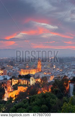 Malaga, Spain cityscape at the Cathedral, City Hall and Alcazaba citadel of Malaga at dusk.