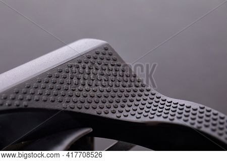 Detail of a new high end graphics card computer hardware upgrade on a desk. Edge of the cooling system
