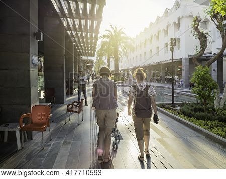 Kemer, Turkey - May 13, 2018. Tourists Walk Down Munir Ozkul Liman Street. Street With Modern Buildi