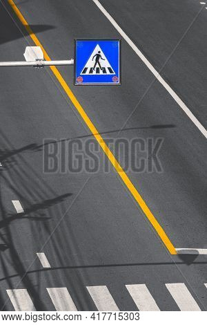 High Angle View And Focus At Overhead Electric Pedestrian Crossing Sign Over Zebra Crossway On Aspha