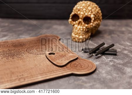 Ouija Board On Grey Background. Mediumship Divination Equipment. Fortune Teller And Black Magic Conc