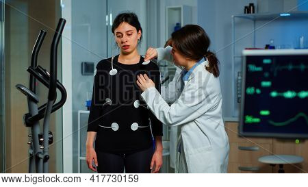 Scientist Researcher Preparing Woman Patient For Endurance Test